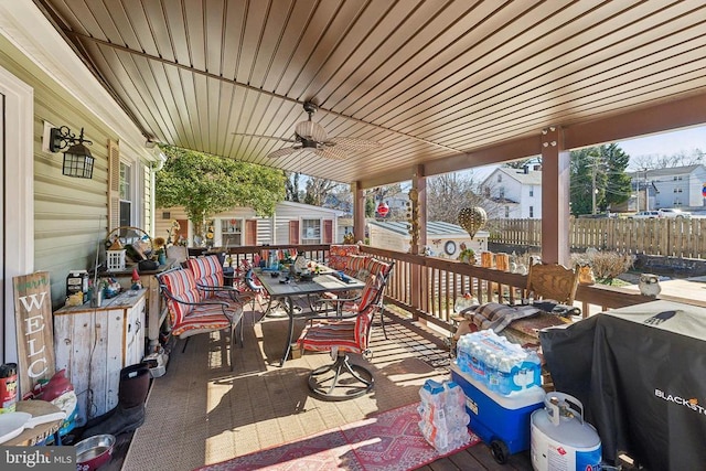 deck with grilling area and ceiling fan