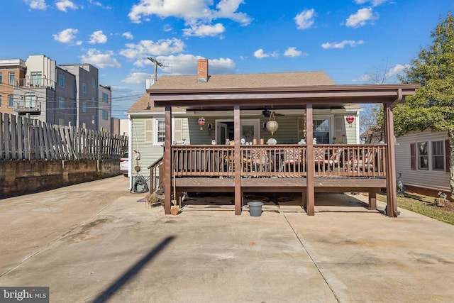 back of house with ceiling fan, a porch, and a patio