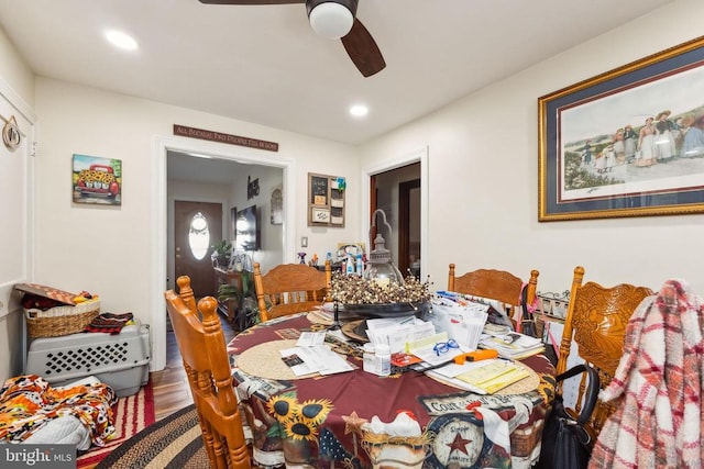 dining space with wood-type flooring and ceiling fan