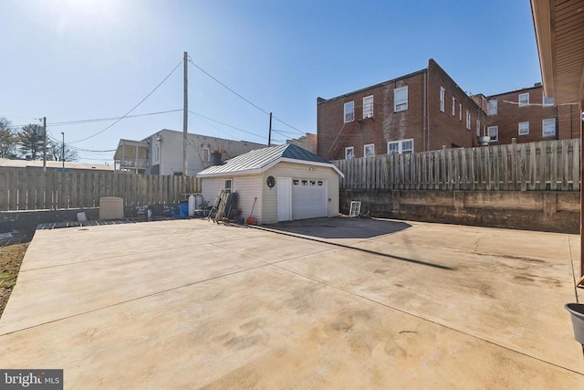 exterior space featuring a garage and an outbuilding