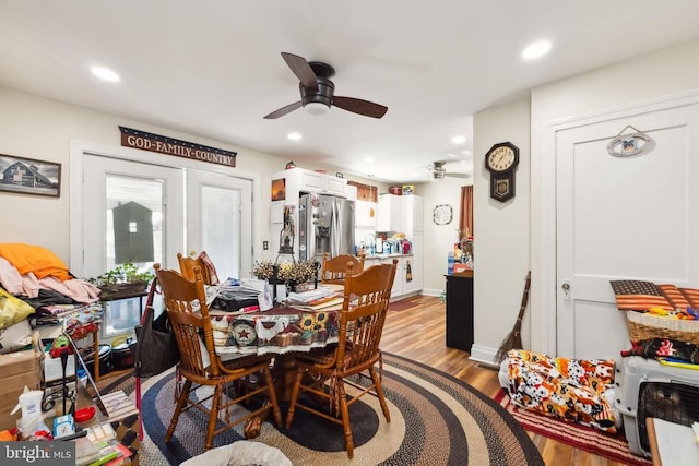 dining area with ceiling fan and light wood-type flooring