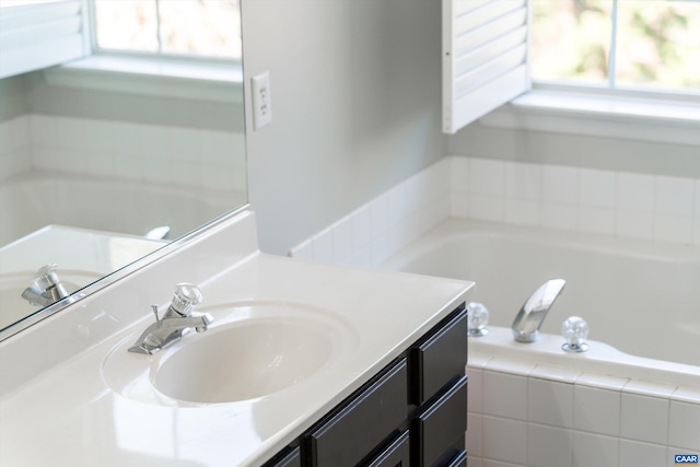 bathroom featuring vanity and a garden tub