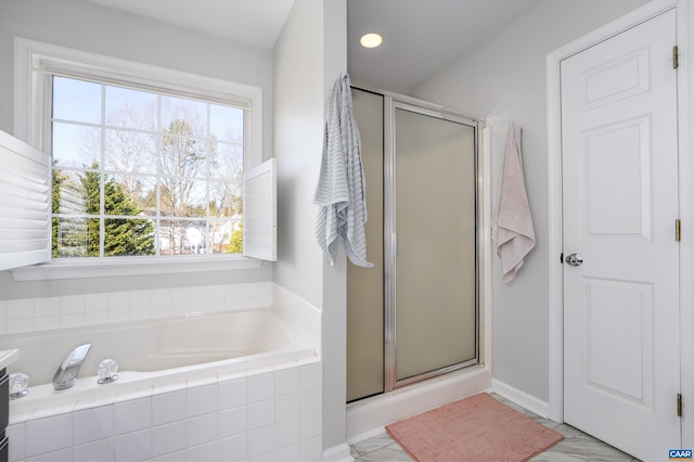 bathroom with a bath and a stall shower