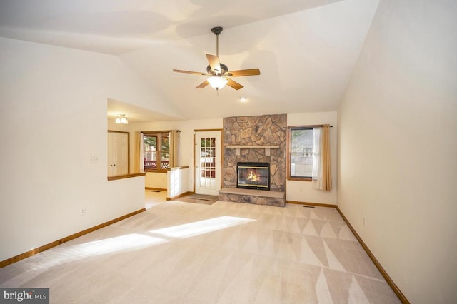 unfurnished living room featuring baseboards, a fireplace, vaulted ceiling, and carpet flooring