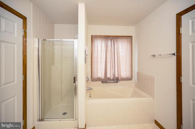 bathroom with a stall shower and a bath