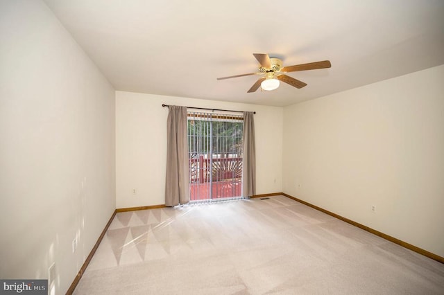 unfurnished room featuring baseboards, a ceiling fan, and light colored carpet