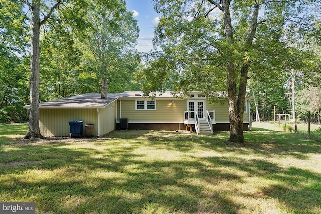 rear view of property with entry steps, french doors, crawl space, a yard, and central AC