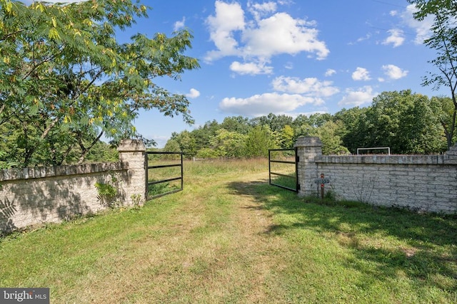 view of yard featuring fence and a gate