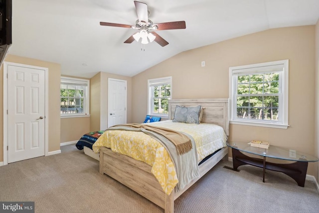 bedroom with carpet, vaulted ceiling, baseboards, and ceiling fan