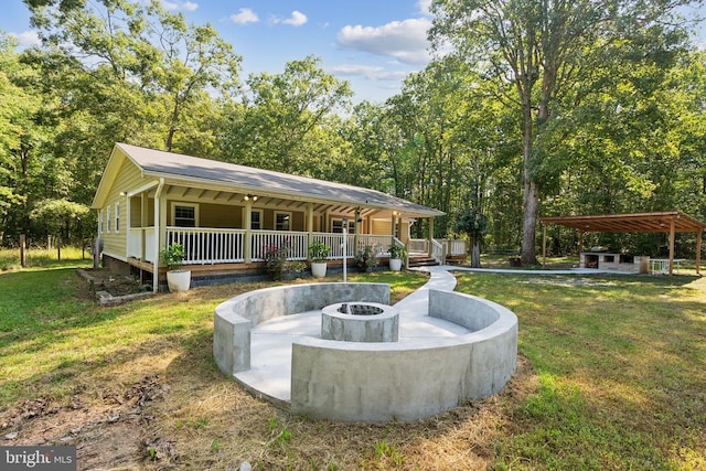 exterior space featuring a lawn and a fire pit