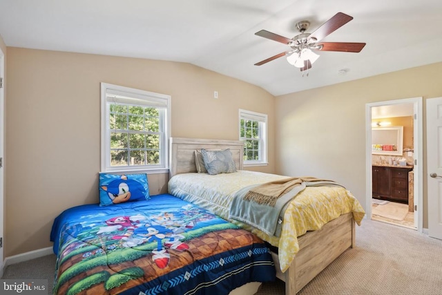 bedroom with baseboards, lofted ceiling, ceiling fan, ensuite bathroom, and carpet flooring