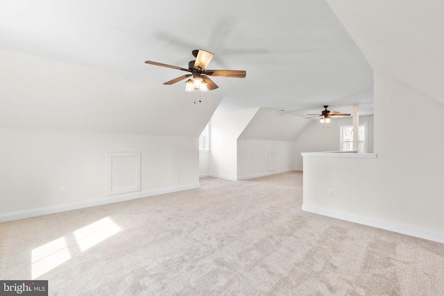 additional living space with carpet floors, vaulted ceiling, and baseboards