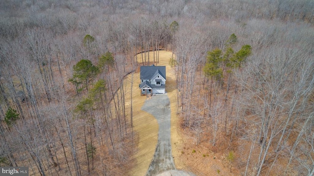 birds eye view of property with a forest view