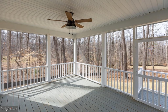 unfurnished sunroom with plenty of natural light and ceiling fan