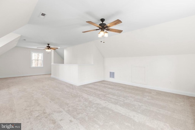 additional living space featuring lofted ceiling, carpet flooring, and visible vents