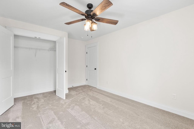 unfurnished bedroom with a closet, carpet flooring, a ceiling fan, and baseboards