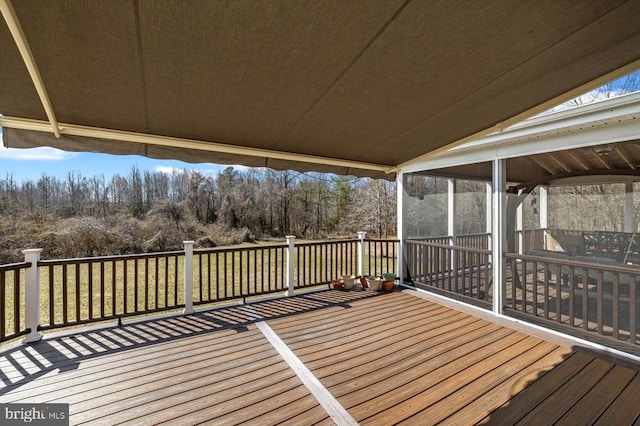 wooden deck featuring a sunroom