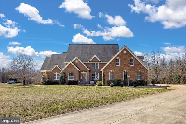 view of front of home featuring a front yard and brick siding