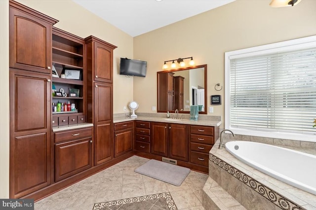 full bath featuring vanity, a bath, and tile patterned floors