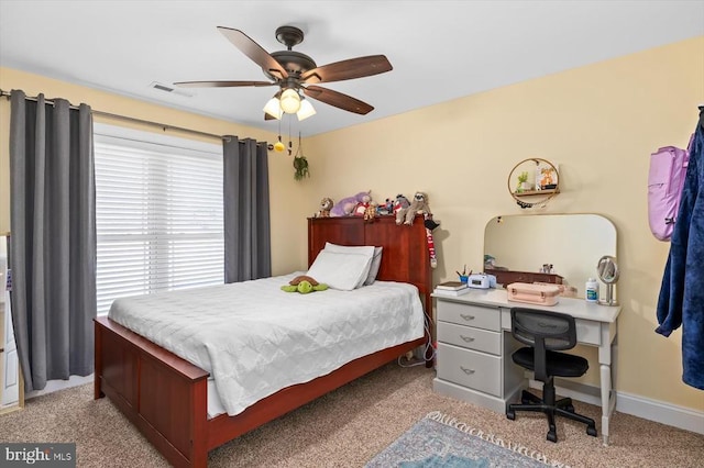 bedroom with baseboards, visible vents, and a ceiling fan