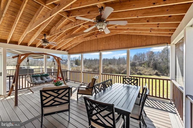 unfurnished sunroom with ceiling fan and vaulted ceiling