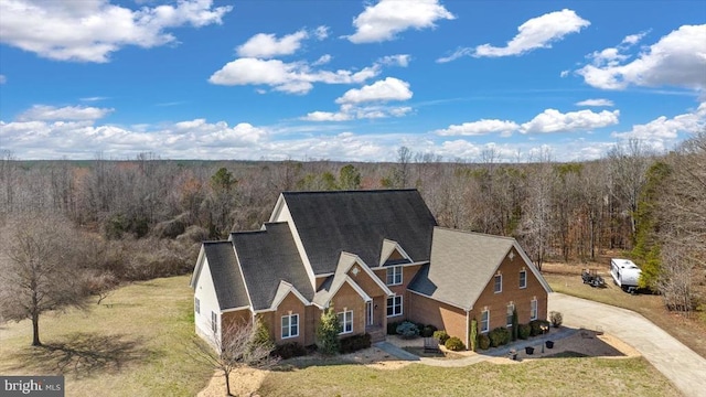 birds eye view of property with a wooded view