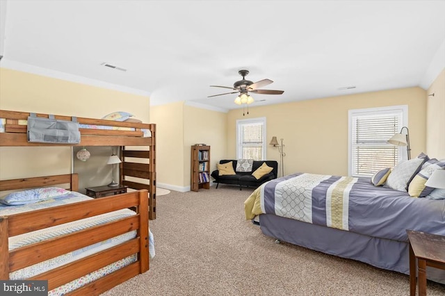 bedroom with multiple windows, carpet, visible vents, and a ceiling fan