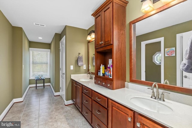 bathroom featuring double vanity, tile patterned flooring, a sink, and visible vents