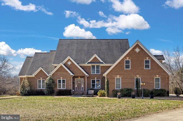 view of front of house featuring a front yard and brick siding