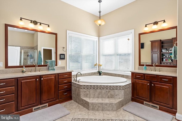 full bathroom featuring a shower stall, visible vents, and a sink