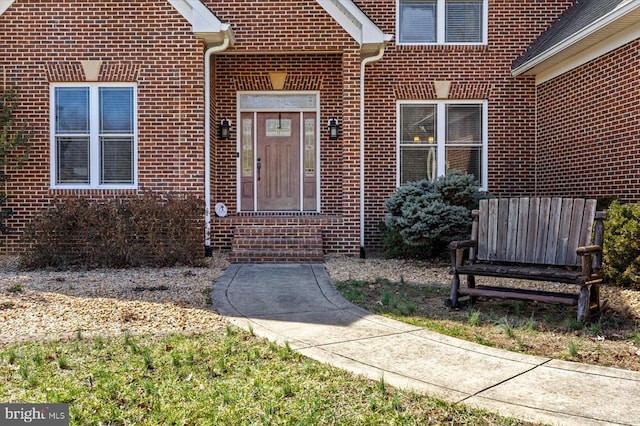 doorway to property with brick siding