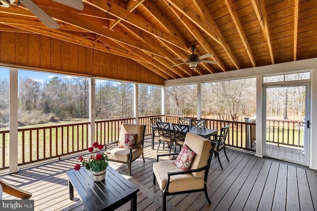 sunroom / solarium featuring vaulted ceiling with beams, wooden ceiling, and ceiling fan