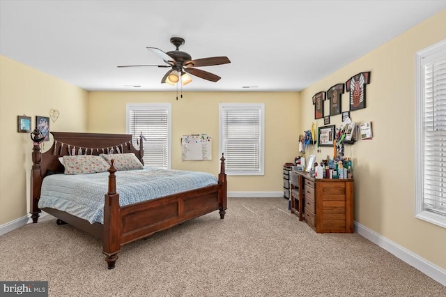 bedroom with baseboards, a ceiling fan, and light colored carpet