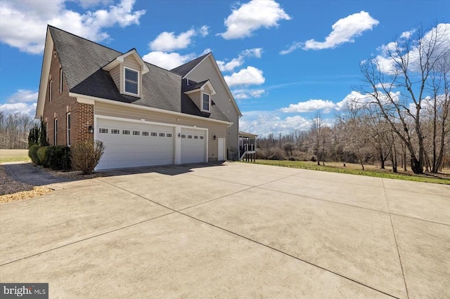 view of property exterior featuring driveway, roof with shingles, a garage, and brick siding