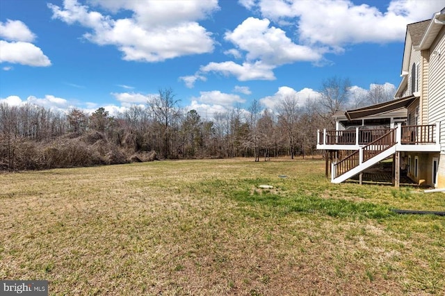 view of yard featuring stairs and a wooden deck