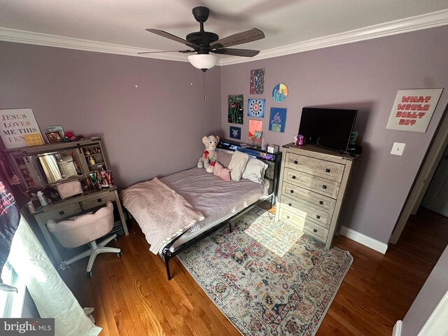 bedroom featuring ceiling fan, ornamental molding, and hardwood / wood-style floors