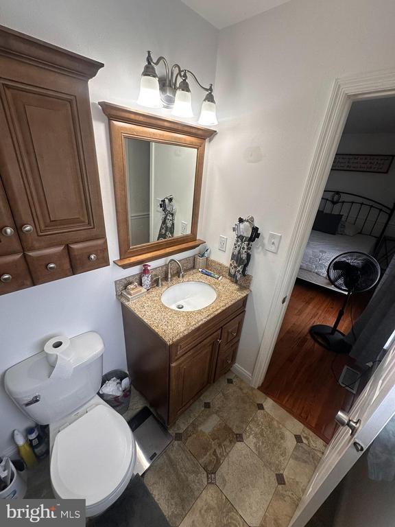 bathroom featuring vanity and toilet