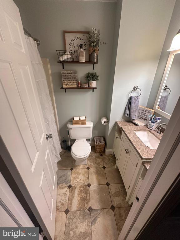 bathroom featuring vanity and toilet