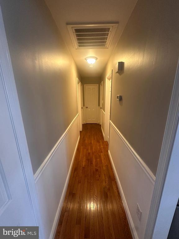 corridor featuring dark wood-type flooring