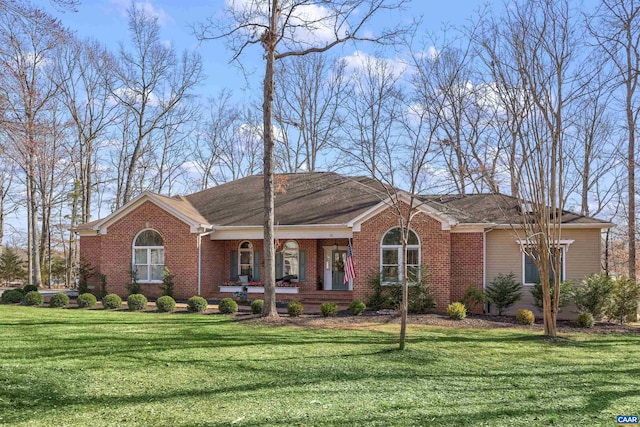 ranch-style house with brick siding, covered porch, and a front lawn