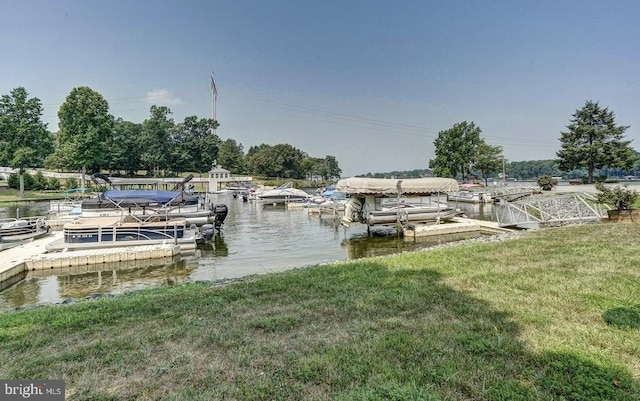 view of dock featuring a water view and a yard