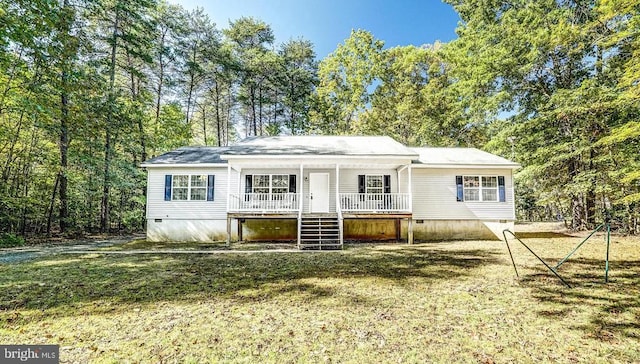 view of front of property with a porch, a front yard, crawl space, and stairway