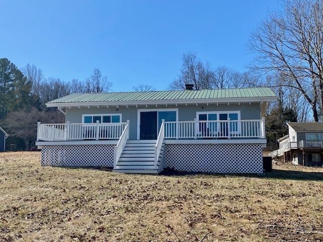 view of front of home featuring a wooden deck and a front lawn