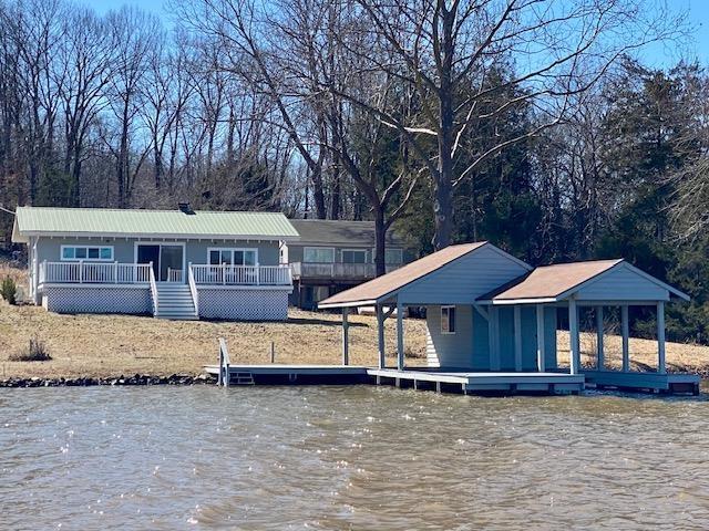 view of front of house featuring a water view and a boat dock