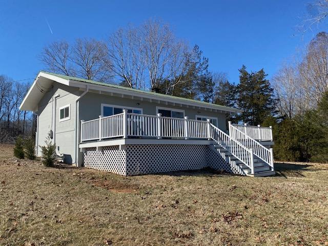 back of house with a yard and a deck