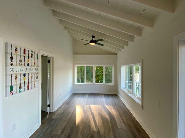 unfurnished sunroom with vaulted ceiling with beams and ceiling fan