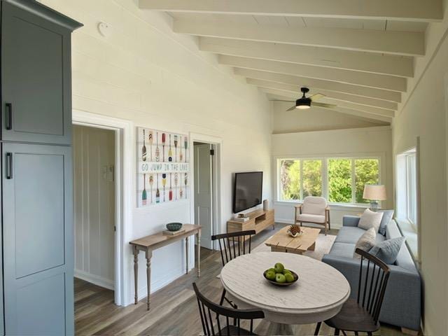 exterior space featuring ceiling fan, lofted ceiling with beams, and wood-type flooring