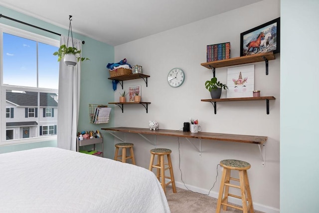 bedroom featuring carpet and baseboards