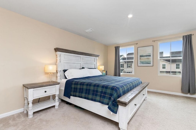 bedroom featuring visible vents, baseboards, and light carpet