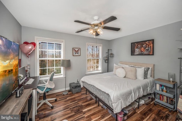 bedroom with ceiling fan, baseboards, and wood finished floors